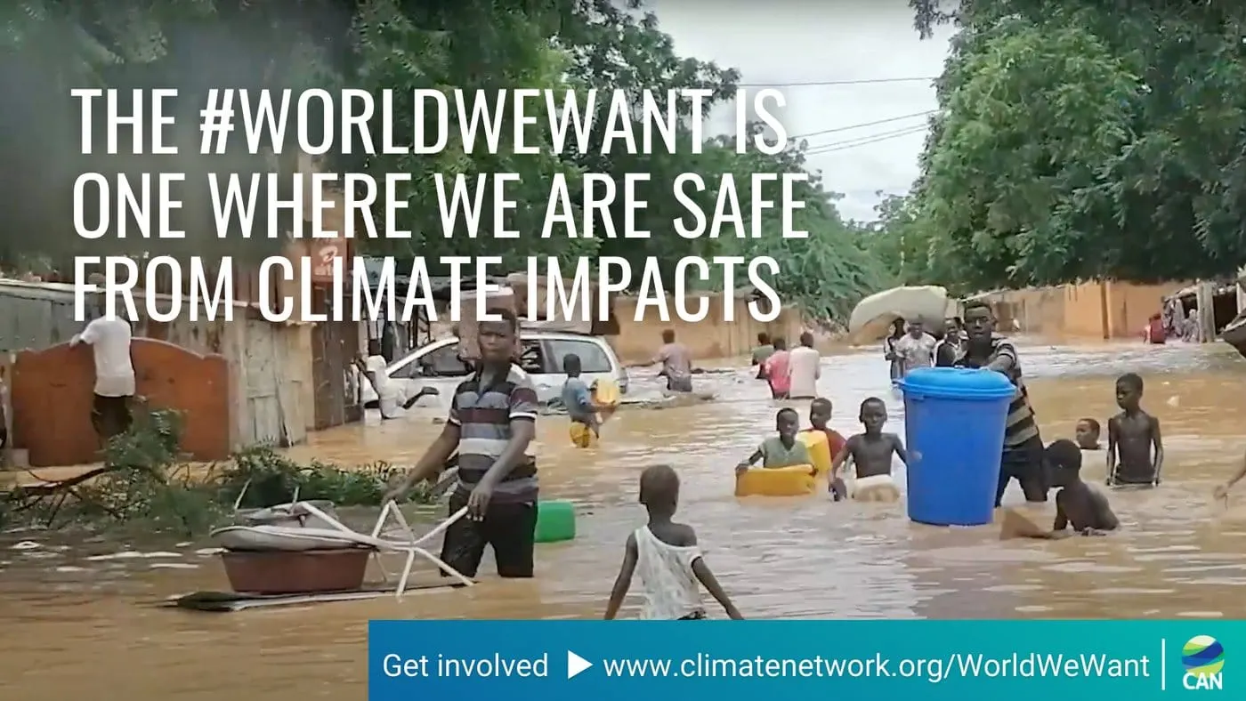 Campaign card over footage of people wading through flooded streets in Niger, reading “The #WorldWeWant is one where we are safe from climate impacts”