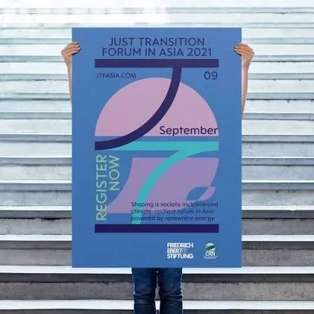 A person holding up the Just Transition Forum in Asia 2021 poster, dated 9 September, with the Friedrich-Ebert-Stiftung and CANSEA logos
