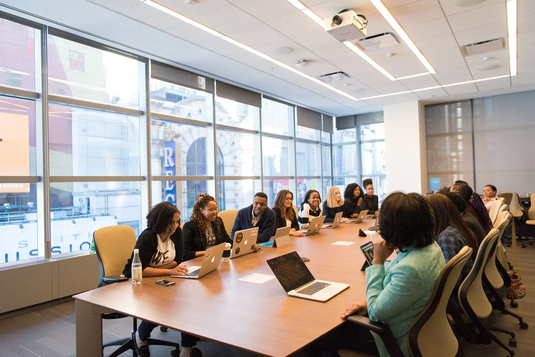 Civil-society representatives convening around a table with laptops